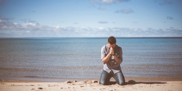 best year ever - man on beach praying
