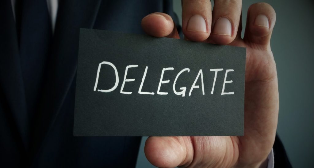 business card that says "Delegate"